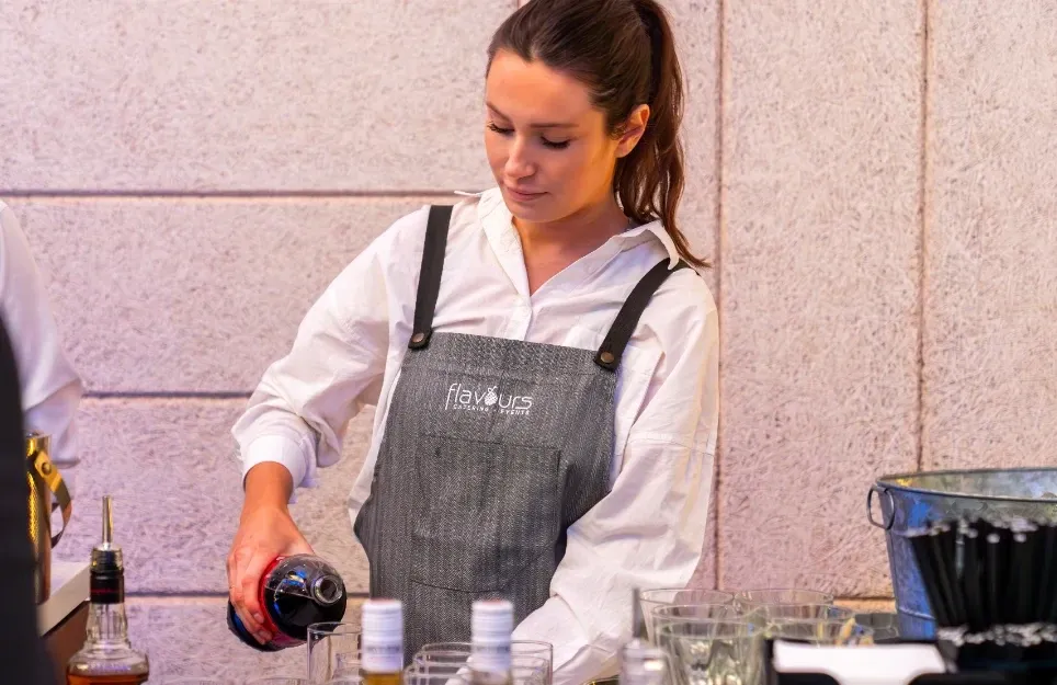 Uniformed wait staff setting up a catering spread at a Sydney memorial venue